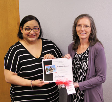 Melissa Brown (left) presents Sue Burks (right) with a fall Campus Kudos Award.