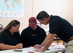 Dr. Dean Scarbrough (right), chair of the Northwestern Oklahoma State University Agriculture Department and professor of agriculture, advises an incoming freshman about enrollment choices during the 2024 Freshman Connection event.