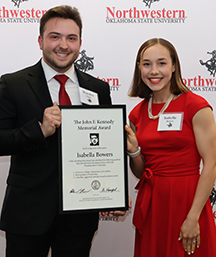 Isabella Bowers (right) receives the John F. Kennedy Award from SGA president Braydon Stoner.